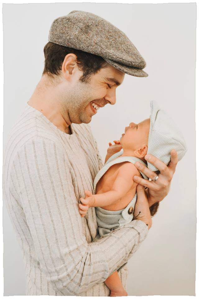 Richard holding his infant son